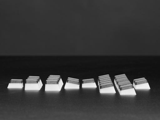 Top view video of black pudding keycaps assembled on a MacroPad. A manicured hand twists the rotary knob, changing the spectrum of rainbow colors glow through the keycaps.