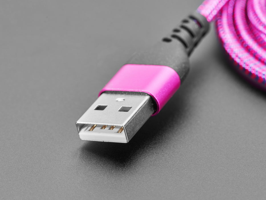 Angled shot of coiled pink and purple USB cable with USB A and USB C connectors.