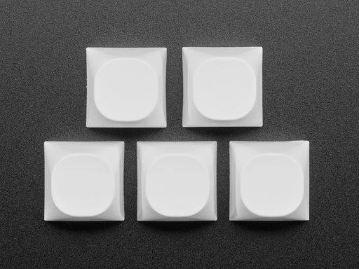 Angled shot of 5 white MA keycaps.