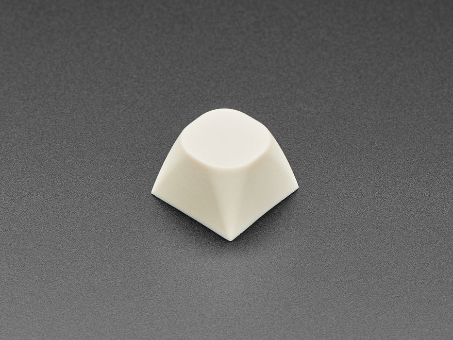 Angled shot of five milky white MA keycap.