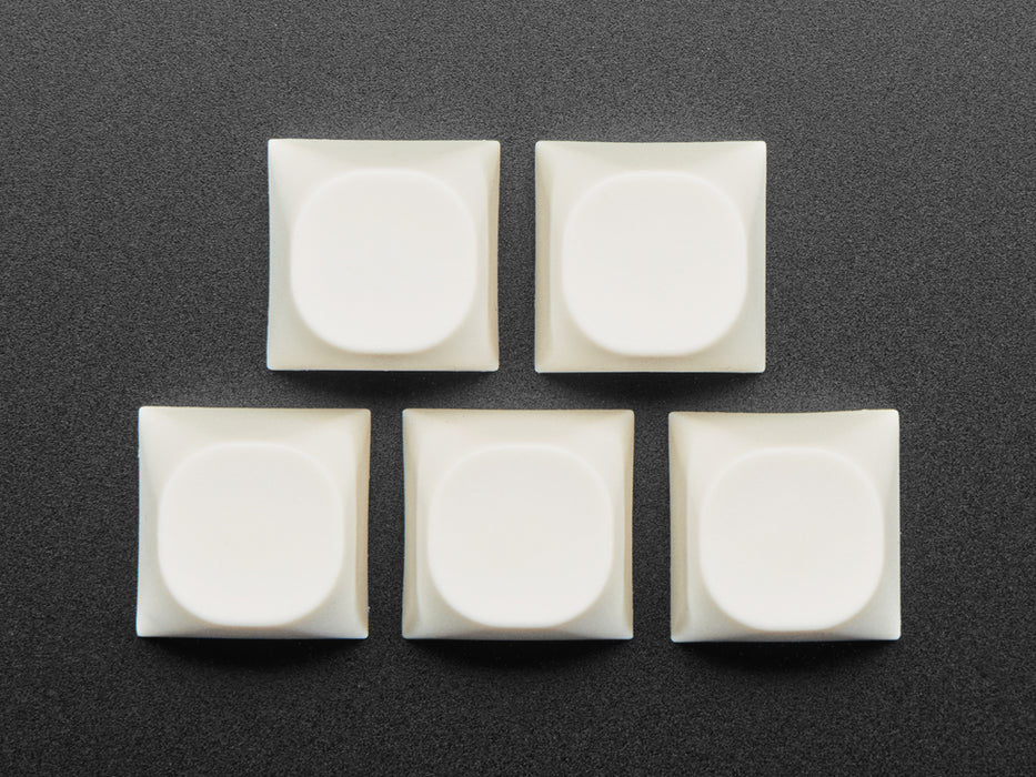 Angled shot of five milky white MA keycap.