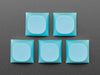 Angled shot of five cyan keycaps.