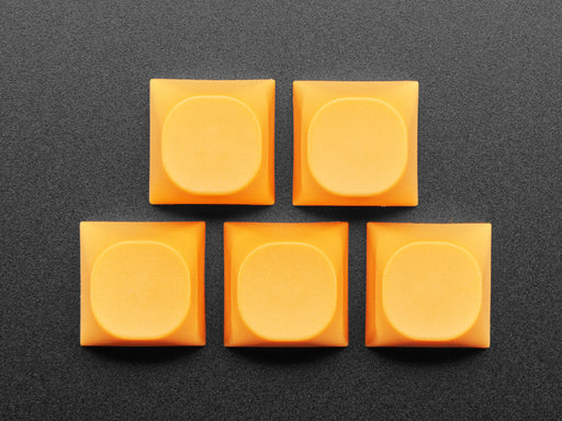 Angled shot of five orange MA keycaps.