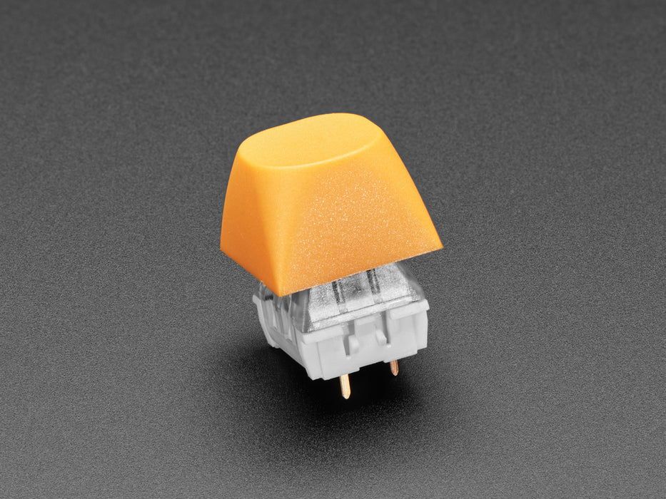 Angled shot of five orange MA keycaps.