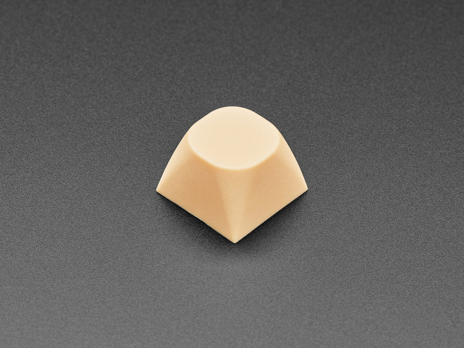 Angled shot of five cream orange MA keycaps. 