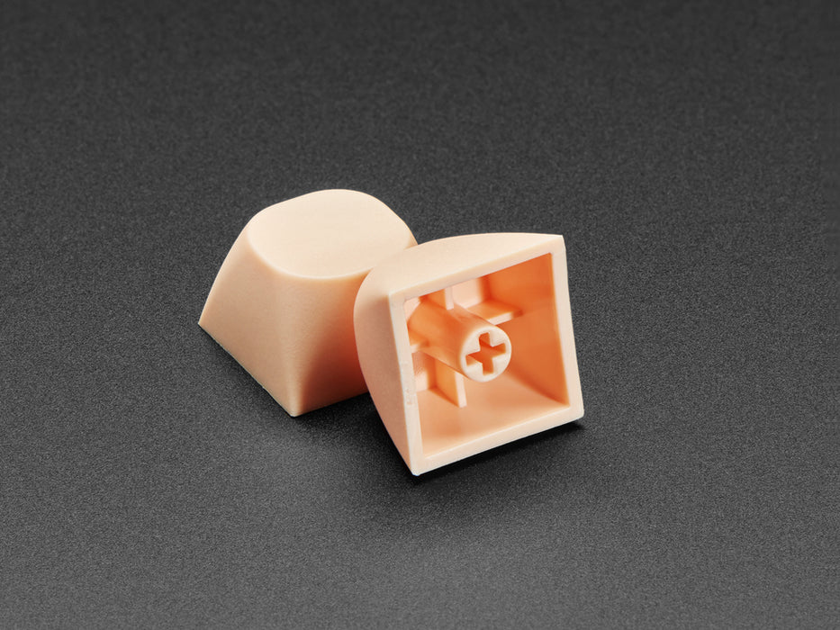 Angled shot of five cream orange MA keycaps. 