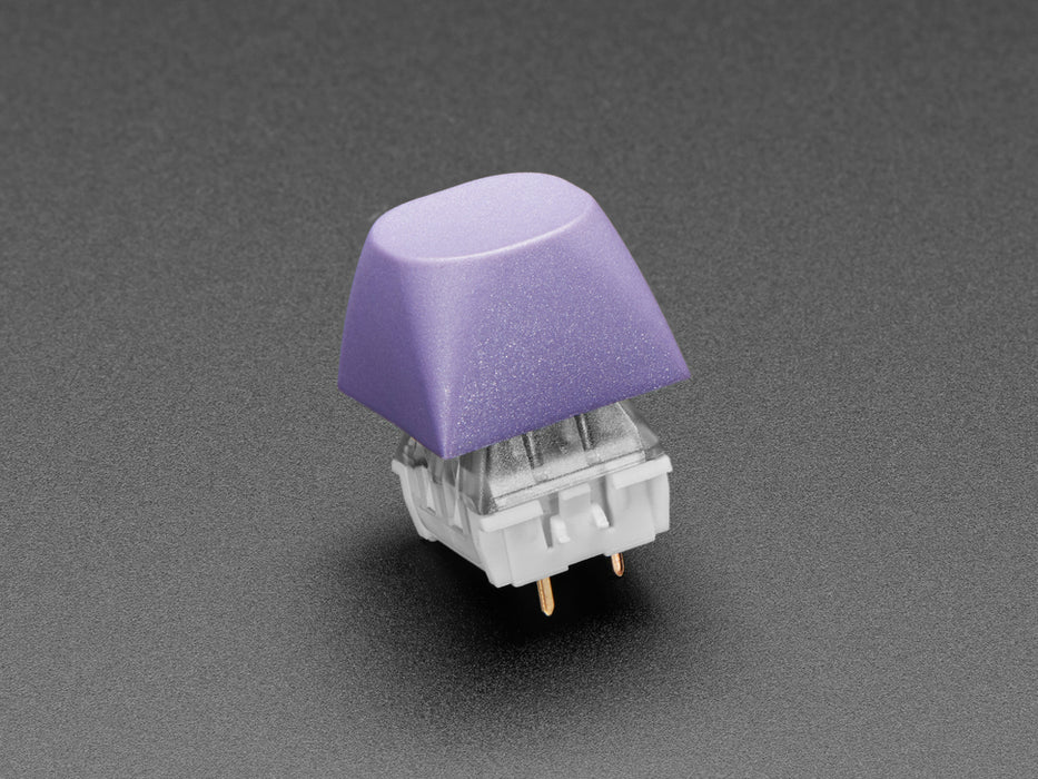 Angled shot of five purple keycaps.