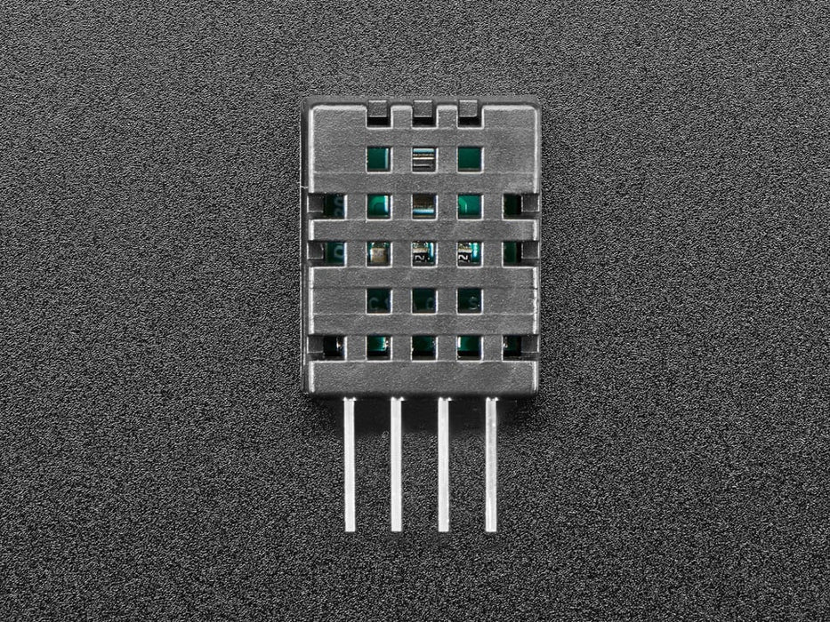 Top view of DHT20 sensor wired to a breadboard with an FeatherWing OLED display. The OLED shows the data from the temperature-humidity sensor.