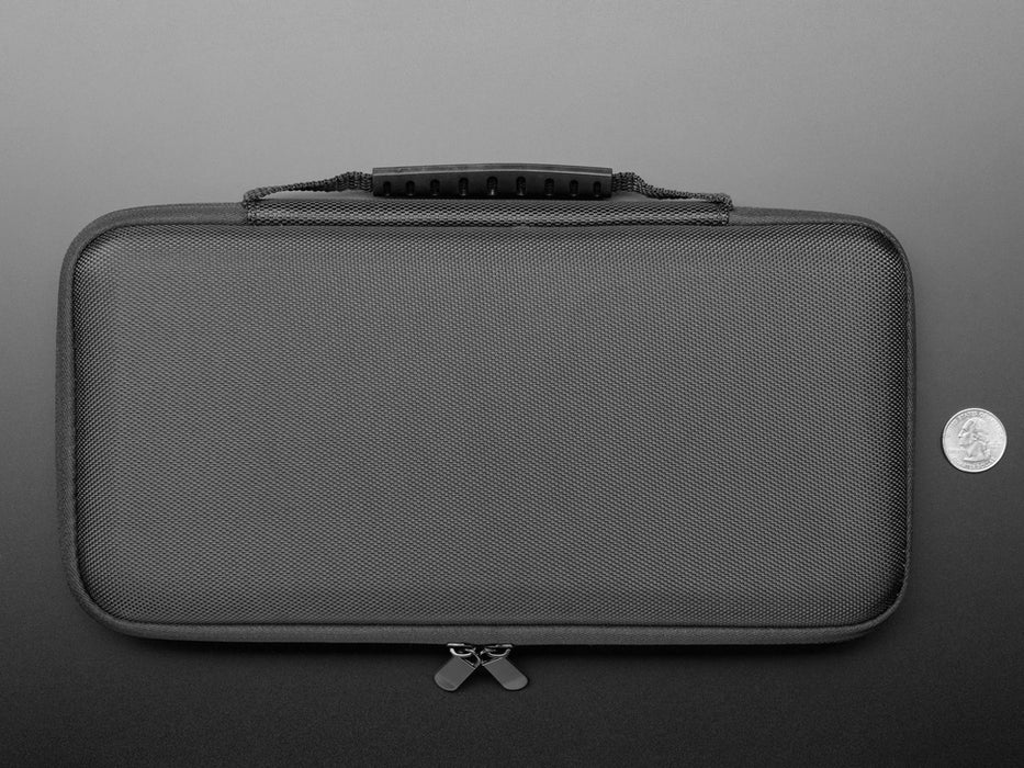 Angled shot of case sleeve opened up with an optical mouse and HDMI cable in the top pocket and a keyboard in the bottom half the case.