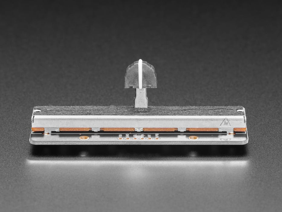 Long rectangular breakout board with a slide potentiometer changing colors as a hand moves up and down.