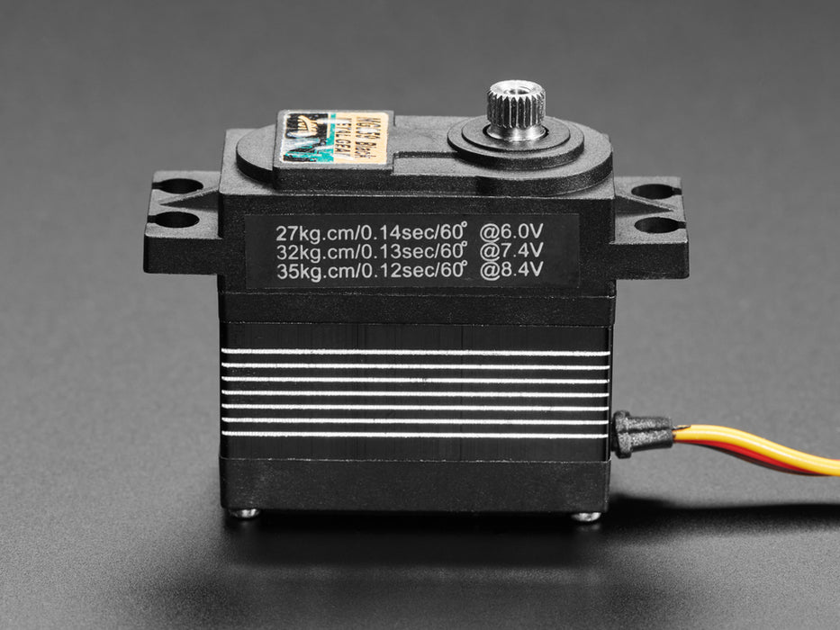 Angled shot of black servo motor with 3-pin jumper cable.