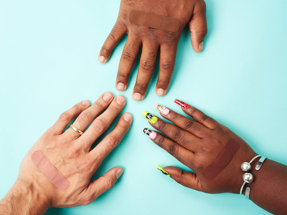 Five sets of bandages in four shades of brown out of their protective paper backing.