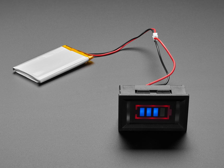 mini battery meter hooked up to a li-poly battery. The display on the battery meter reads three out of four blue tiers.