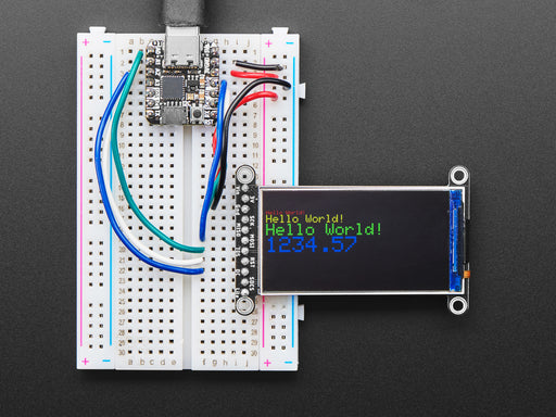 TFT display breakout soldered and assembled onto a half-size breadboard and wired up to a microcontroller. The color TFT screen displays a cycle of animations.