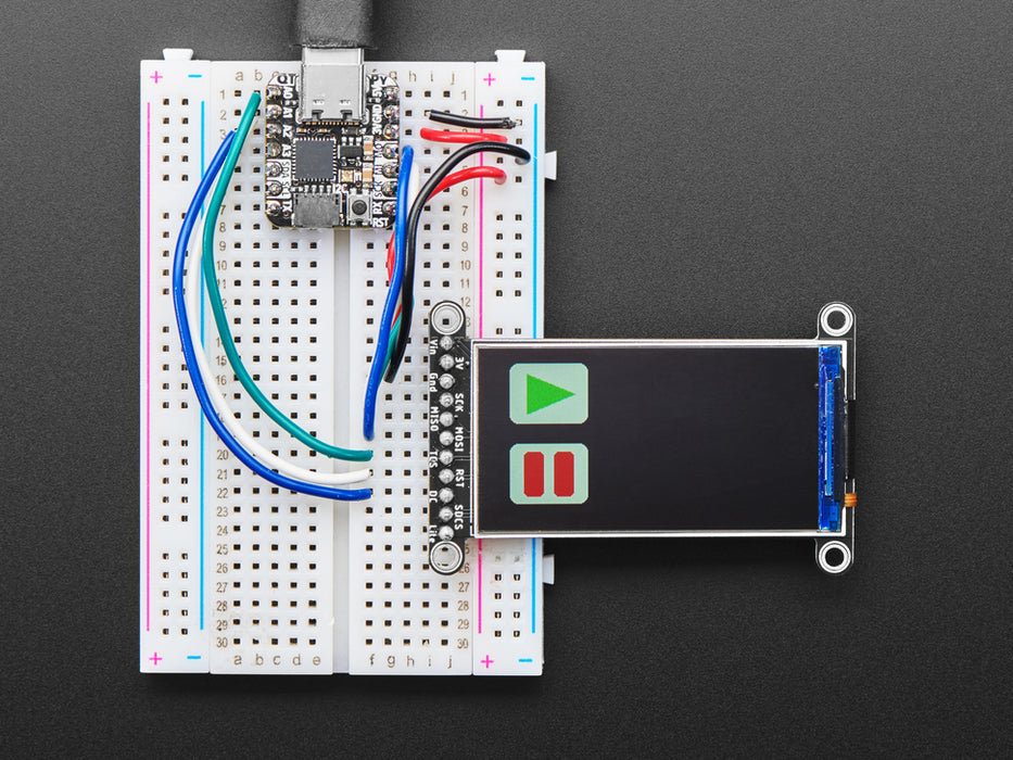 TFT display breakout soldered and assembled onto a half-size breadboard and wired up to a microcontroller. The color TFT screen displays a cycle of animations.