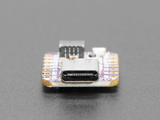 Angled shot of purple square-shaped microcontroller.