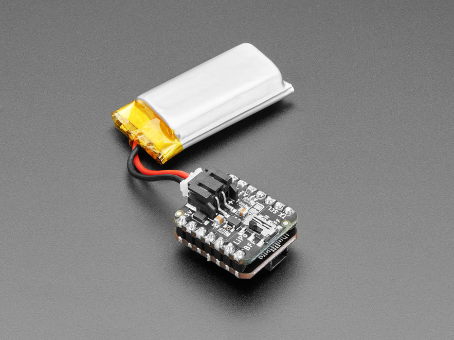 Video of a person with white painted nails unplugging a USB cable from a small, black, square-shaped lipo battery breakout board soldered to a similarly shaped microcontroller, which is also connected to a monochrome OLED display breakout. The OLED breakout displays battery and power data.