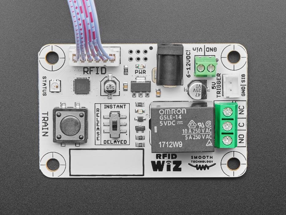 Angled shot of a white board connected to a red board via ribbon cable.