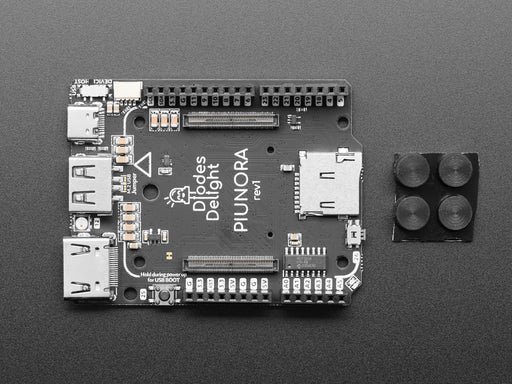 Rectangular compute module placed on a bigger microcontroller.