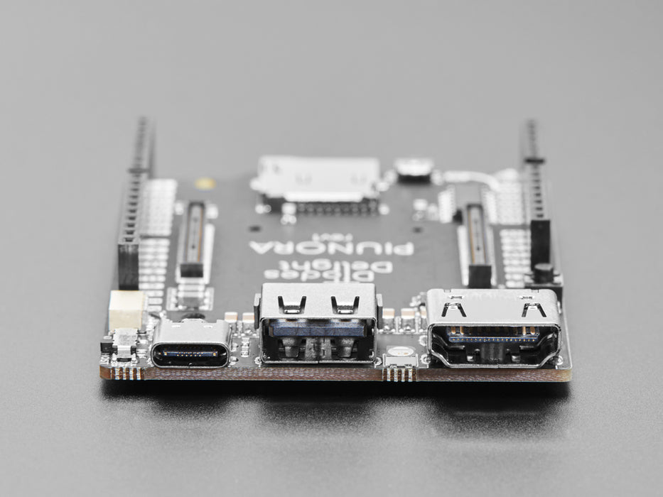 Rectangular compute module placed on a bigger microcontroller.