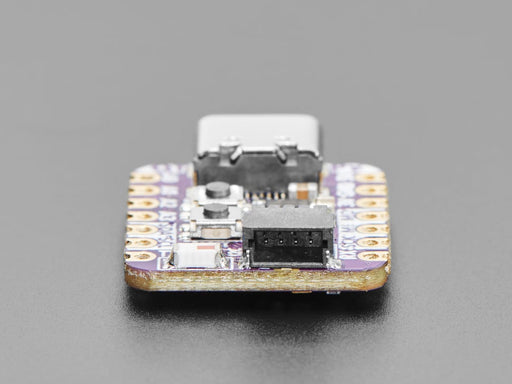 Angled shot of an Adafruit QT Py ESP32-C3 WiFi Dev Board with STEMMA QT.