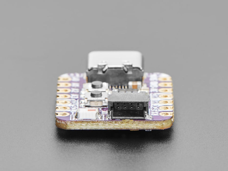 Angled shot of an Adafruit QT Py ESP32-C3 WiFi Dev Board with STEMMA QT.