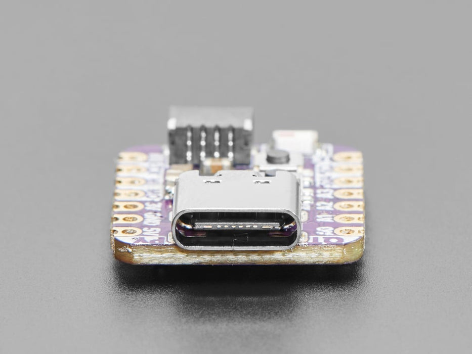 Angled shot of an Adafruit QT Py ESP32-C3 WiFi Dev Board with STEMMA QT.