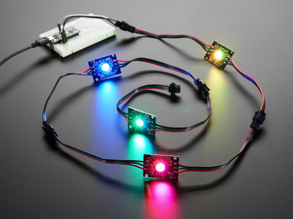 Video of four chained LED PCBs glowing rainbow colors.