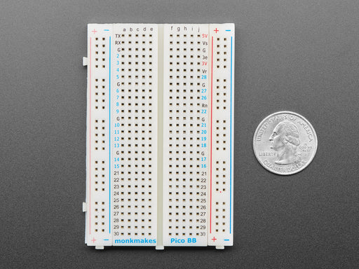 Half-size breadboard with a soldered skinny green microcontroller.