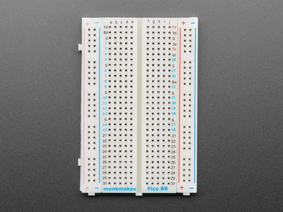 Half-size breadboard with a soldered skinny green microcontroller.