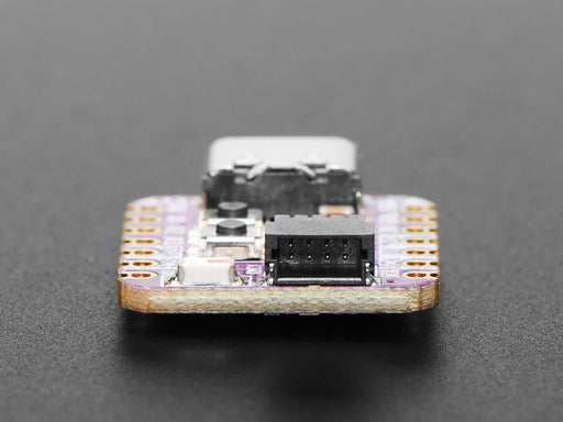 Angled shot of small purple microcontroller.