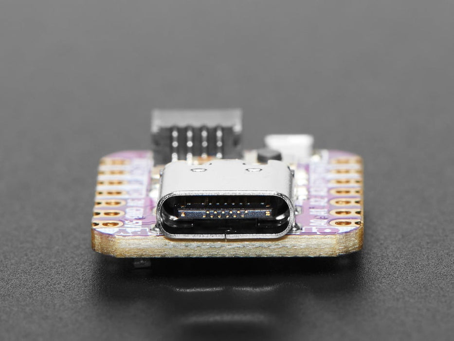 Angled shot of small purple microcontroller.