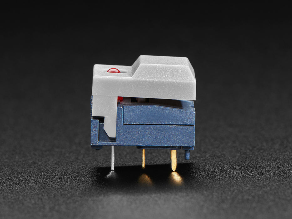 Angled shot of three gray plastic step switches with LED.