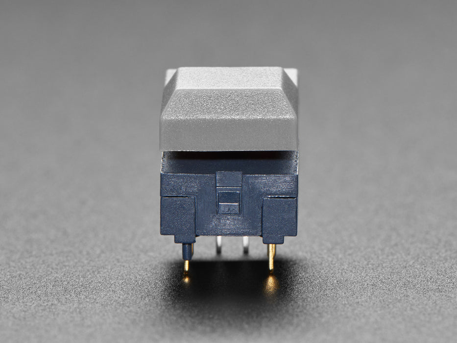 Angled shot of three gray plastic step switches with LED.