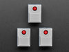 Angled shot of three gray plastic step switches with LED.