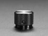 Angled shot of a black aluminum knob. A white triangle on top of the knob points at 5:00. 