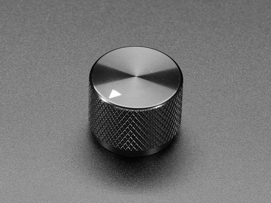 Angled shot of a black aluminum knob. A white triangle on top of the knob points at 5:00. 