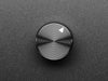 Angled shot of a black aluminum knob. A white triangle on top of the knob points at 5:00. 