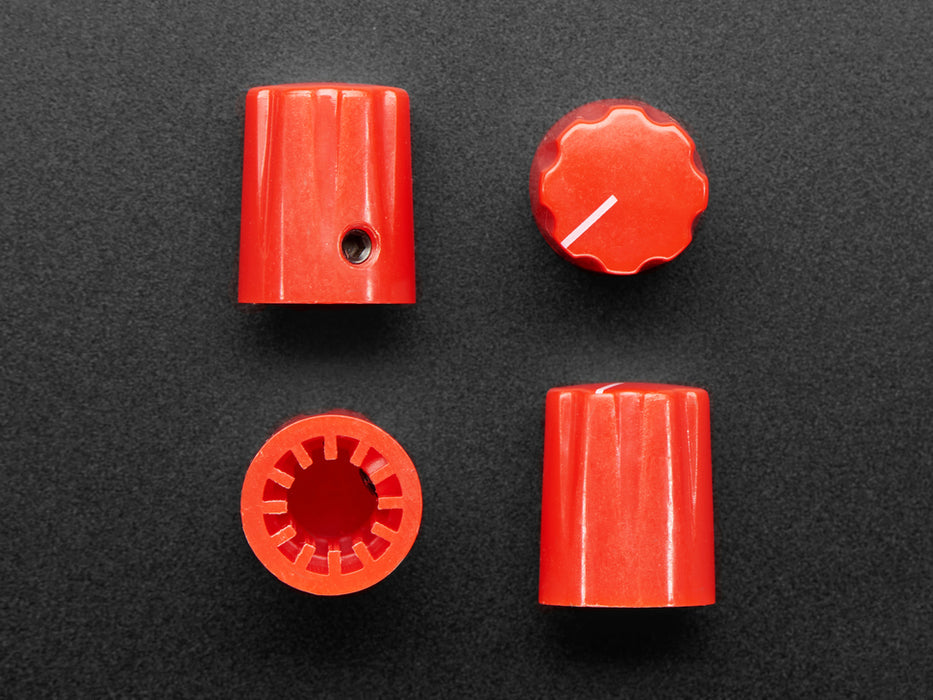 Angled shot of four red micro potentiometer knobs.