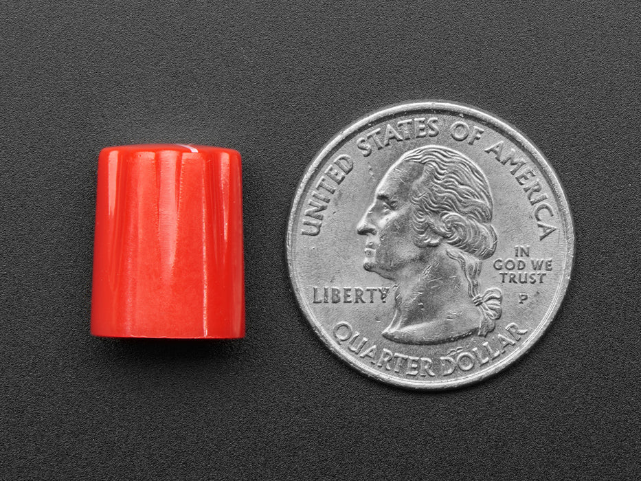 Angled shot of four red micro potentiometer knobs.