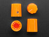 Angled shot of four orange micro knobs.