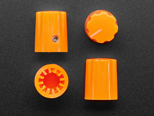 Angled shot of four orange micro knobs.