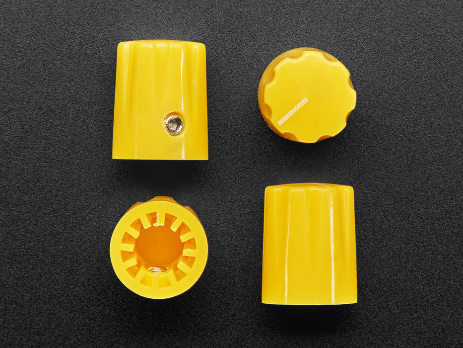 Angled shot of four yellow micro knobs.