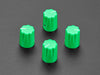 Angled shot of four green plastic micro knobs.