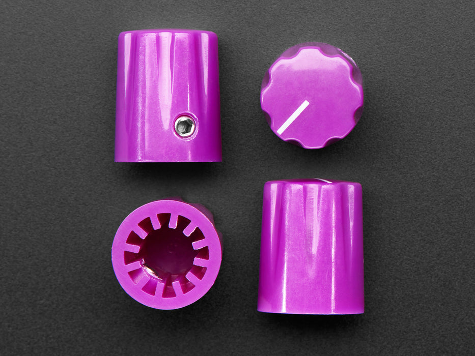 Angled shot of  four violet-purple plastic micro knobs.