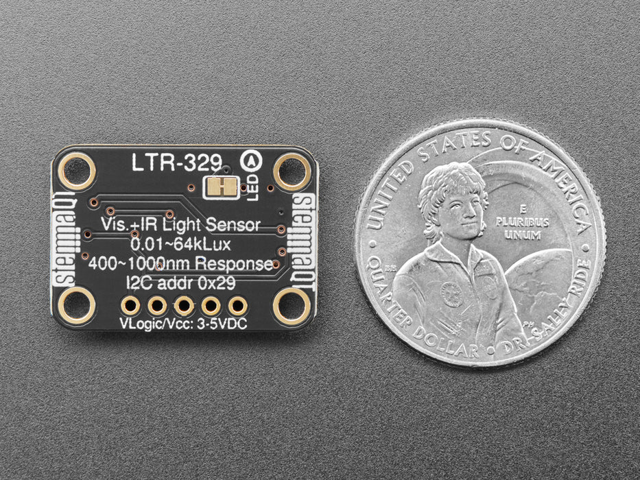 Overhead video of a white person's hand covering a light sensor breakout, which changes the visibility and infrared data on an OLED display breakout.