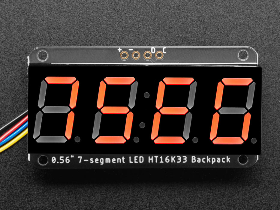 Red 7-segment clock display soldered to backpack with all segments lit