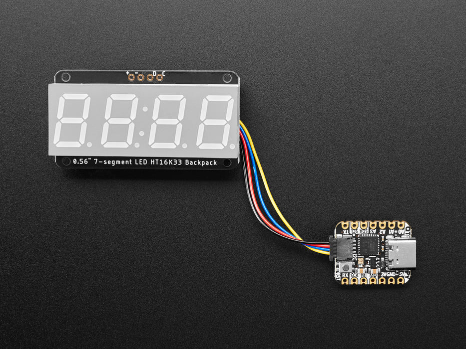 Red 7-segment clock display soldered to backpack with all segments lit