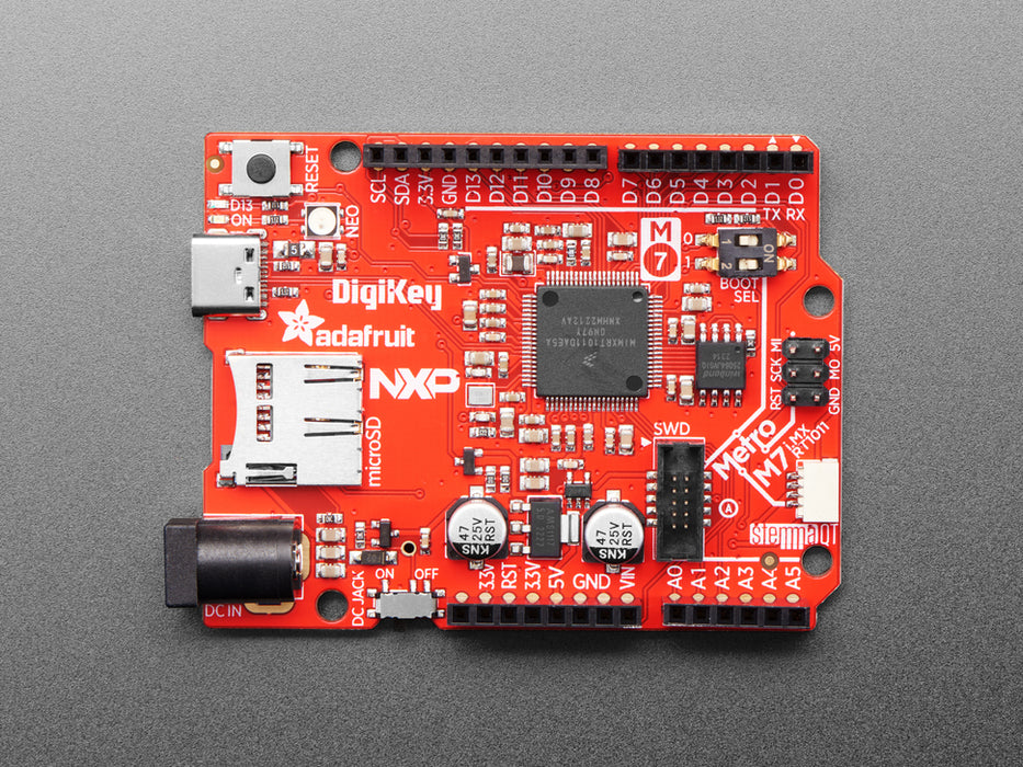 Angled shot of red credit-card sized microcontroller.