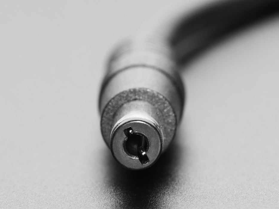 Angled shot of a round panel mount adapter cable installed in an orange square acrylic plate.